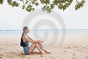 nature woman sea travel freedom smile sitting vacation beach alone sand