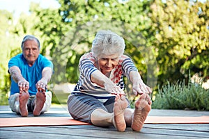 Nature, yoga stretching and senior couple start outdoor exercise, training workout or health fitness on park floor