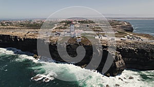 Nau dos Corvos or Ship of Crows and lighthouse, Carvoeiro cape, Peniche in Portugal. Aerial forward