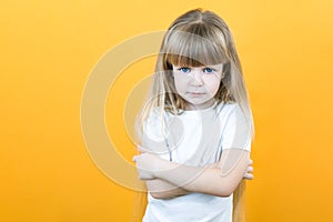 Naughty child. Disobedience problem. discipline punishment. Portrait of cute angry offended little girl in white with crossed arms