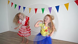 naughty female children shake they red and blond hair heads and dance