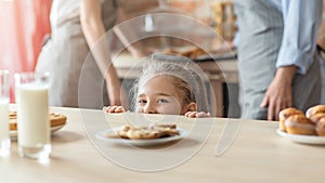 Naughty little girl going to get some cookies