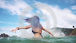 Naughty woman in the sea splashing water