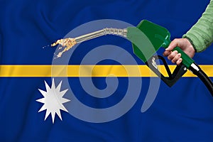 NAURU flag Close-up shot on waving background texture with Fuel pump nozzle in hand. The concept of design solutions. 3d rendering
