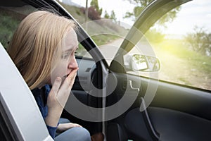 Nausea during a car trip. A blonde woman suffers from kinetosis. The concept of motion sickness in diseases of the transport and