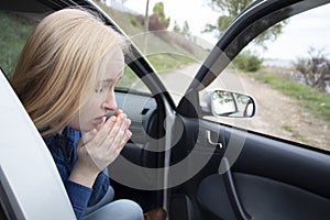 Nausea during a car trip. A blonde woman suffers from kinetosis. The concept of motion sickness in diseases of the transport and