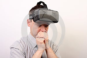 A nauseous, dizzy, disturbed man wearing Oculus Rift VR virtual reality headset after a negative experience