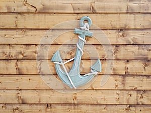 Nautical Anchor on Brown Wood Panel Wall