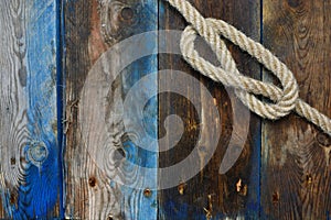 Nautical background. Nautical rope on a weathered desk. Sea travel background.