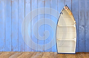 Nautical boat shape shelves on wooden table. product display background, vintage filtered