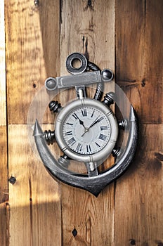 A nautical clock on a wooden backgroundâ€™