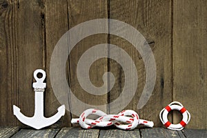 Nautical decoration with anchor and knot on wood.