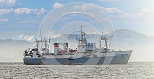 Nautical fishing coracles on sea on soft sunlight