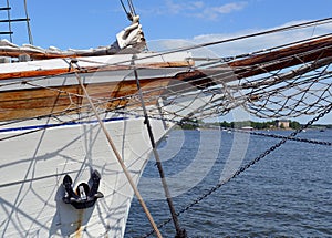 Nautical maritime scene with ropes and mast on a ship on a dock by the water