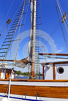 Nautical maritime scene with ropes and mast on a ship on a dock by the water