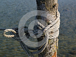 Nautical old mooring rope of a small fishing boat