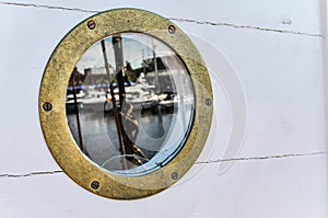 Nautical porthole With reflection, close up