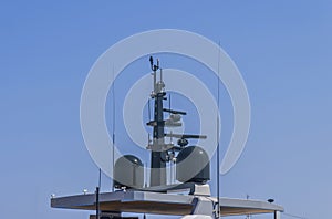 Nautical radio radar and antena at luxury yacht docked at marina