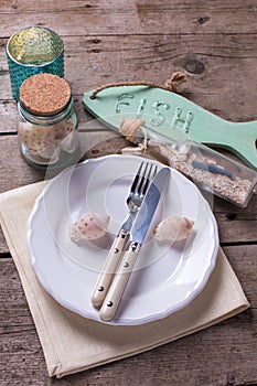 Nautical table setting on aged wooden background.