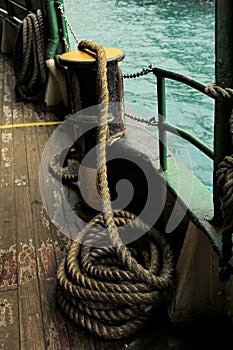 Nautical vessel heavy anchored rope, transportation equipment in selective focus.