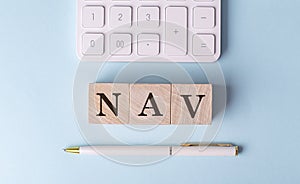 NAV on wooden cubes with pen and calculator, financial concept