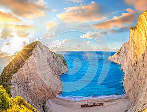 Navagio beach with shipwreck against colorful sunset on Zakynthos island in Greece