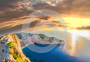 Navagio beach with shipwreck against sunset on Zakynthos island in Greece