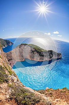 Navagio beach with shipwreck against sunset on Zakynthos island in Greece