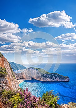 Navagio beach with shipwreck and flowers against sunset on Zakynthos island in Greece