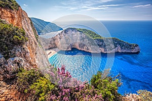 Navagio beach with shipwreck and flowers against sunset on Zakynthos island in Greece photo