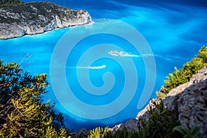 Navagio beach, Zakynthos, Greece. Tourist trip boats visiting and leaving Shipwreck bay with turquoise water beach