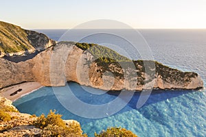 Navagio view from cliff during sunset.