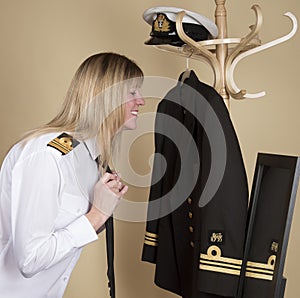 Naval officer tying her tie