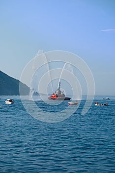 Two jets of sea water sprayed by a fire engine of a firefighters