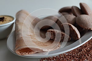 Navara rice idly and ghee roast dosa served together on a plate