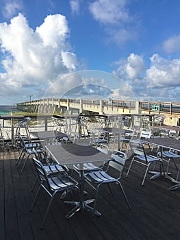 Navarre Beach, Florida, fishing pier and adjacent outdoor restaurant dining area. Copy space.