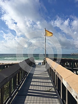 Navarre Beach, Florida, yellow caution flag and ramp to the beach.