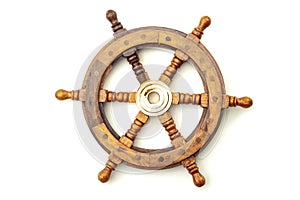 Navigation, nostalgia for bygone age of discovery and leadership conceptual idea with vintage ship steering wheel rudder made of