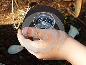 Navigational compass held in hand