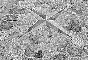 A navigational compass laid out on the pavement
