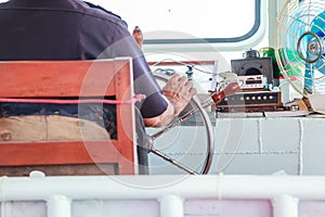 Navigator helmsman is responsible for position of ferry boat by controlling steering wheel helm, sternwheel in pilot house.