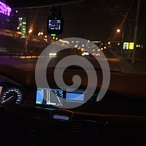Navigator panel of the car at night. The city lights