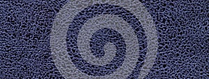 Navy blue background of fabric with wavy pattern, closeup. Velvet texture of seamless denim textile, macro