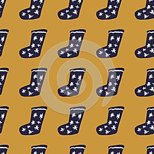 Navy blue colored xmsx socks seamless doodle pattern. Ocher background. Winter cozy clothes with stars ornament