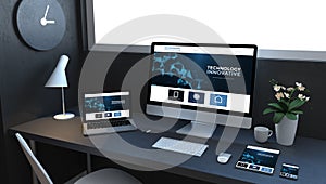 navy blue responsive devices on desktop showing technology website