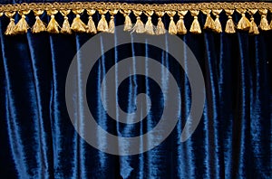 Navy blue velvet curtain with gold brocade fringe at top - image