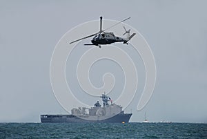 Navy helicopter and battleship photo