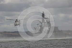 Navy helicopter and warship