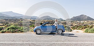 Naxos, Greece - May 2018: woman drives convertible blue car on mountain road