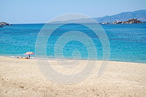 Naxos, Greece. Mikri Viglia beach. Summers day, golden sands, deep blue sea. Copy space.